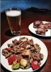  ?? PHOTO BY WYATT WILLIAMS ?? The spicy stewed chicken gizzards and krakro (plantain dumplings) at Cafe Songhai pair well with beer.