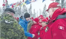  ?? ANDREW VAUGHAN/THE CANADIAN PRESS ?? Prime Minister Justin Trudeau meets with members of the Canadian Rangers in Happy Valley-Goose Bay, N.L., on Nov. 24. The Defence Department ombudsman says the military should be doing more to provide health support for the Canadian Rangers who patrol...