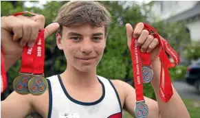  ?? BEJON HASWELL/STUFF ?? William Laing displays his medals from the Colgate Games which earned him a scholarshi­p in the name of top New Zealand middle-distance runner Nick Willis.