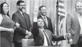  ?? STEPHEN M. DOWELL Orlando Sentinel via AP ?? Gov. Ron DeSantis throws a pen after signing the budget on Thursday in The Villages.