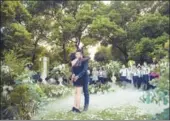  ?? PROVIDED TO CHINA DAILY ?? A man proposed to his girlfriend at a Shanghai garden well decorated with flowers from Florantic.