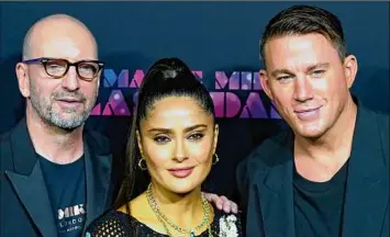 ?? Wilfredo Lee / Associated Press ?? Director Steven Soderbergh, left, stands with Salma Hayek and Channing Tatum on the red carpet at the premiere of, “Magic Mike’s Last Dance,” on Jan. 25 in Miami Beach, Fla.