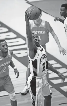  ?? PAT A. ROBINSON / FOR THE JOURNAL SENTINEL ?? Riverside’s Terrence Lewis reaches for a rebound Tuesday in the Tigers’ win over Arrowhead.