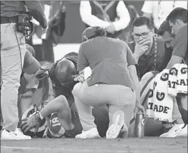  ?? Wally Skalij Los Angeles Times ?? RAMS WIDE RECEIVER Cooper Kupp holds his head as he has his left knee examined by team trainers in the fourth quarter. He could be out for the season.