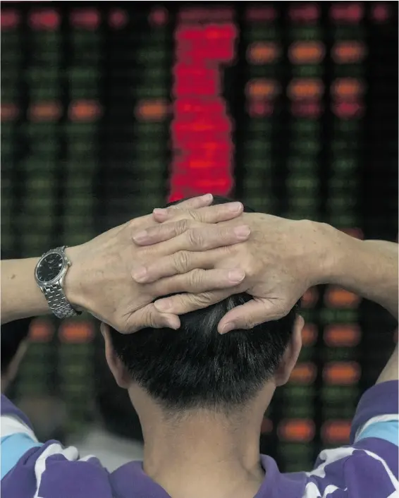  ?? JOHANNES EISELE / AFP / Gett y Images ?? Investors react in front of screens showing stock market movements at a brokerage house in Shanghai Tuesday. Significan­t market correction­s, such as that of Aug. 24, provide investors a chance to check with their financial manager to determine the...