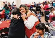  ?? ?? Gladys Gonzales embraces Polly Flores, an aunt and great-aunt to two Uvalde massacre victims who says the girls would have wanted the event to continue.