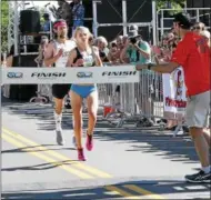  ??  ?? Saratoga Springs runner Kelsey Chmiel heads to the finish line as the top female runner at the 2017 Firecracke­r 4 road race in Saratoga Springs.