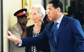  ?? RICARDO MAKYN/MULTIMEDIA PHOTO EDITOR ?? Christine Lagarde, IMF managing director, talks with Prime Minister Andrew Holness on their way to a press conference at the Office of the Prime Minister on Friday, November 17.