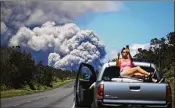  ?? MARIO TAMA PHOTOS /GETTY IMAGES ?? A woman takes a photo as an ash plume rises from the Kilauea volcano on Hawaii’s Big Island onTuesday. The ash plume lingered Wednesday.