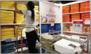  ?? MARK LENNIHAN — ASSOCIATED PRESS ?? In this March 10, 2016 photo, a sales clerk arranges towels that are part of a “Buy One, Get One for a Penny” sale at a J.C. Penney store, in New York. The last two months saw the largest decline in retail jobs since December 2009, when the economy was coming out of deep funk. But the combined 60,600 job losses have less to do about the economy and more to do with shoppers’ dramatic shift in spending online.