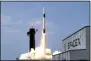  ?? THE ASSOCIATED PRESS ?? In this May 30, 2020, file photo, a SpaceX Falcon 9, with NASA astronauts Doug Hurley and Bob Behnken in the Dragon crew capsule, lifts off from Pad 39-A at the Kennedy Space Center in Cape Canaveral, Fla. For the first time in nearly a decade, astronauts blasted towards orbit aboard an American rocket from American soil, a first for a private company.