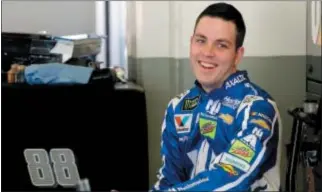  ?? (AP PHOTO/TERRY RENNA) ?? Alex Bowman smiles to team members in his garage during a practice session for the Clash NASCAR auto race at Daytona Internatio­nal Speedway, Friday, Feb. 17, 2017, in Daytona Beach, Fla.