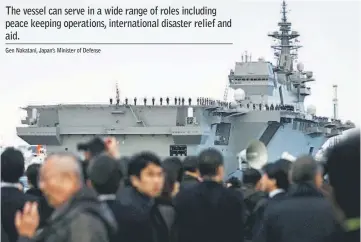  ??  ?? People watch the departure of the Izumo warship from the harbour of Japan United Marine shipyard in Yokohama, south of Tokyo. — Reuters