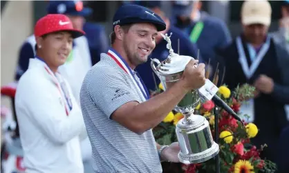  ??  ?? Bryson DeChambeau celebrates with the US Open trophy after winning as the low amateur John Pak (left) looks on after the final round at Winged Foot. Photograph: Gregory Shamus/Getty Images