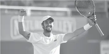  ?? AGENCE FRANCE PRESSE ?? Australia's Jordan Thompson celebrates winning his first round match against Britain's Andy Murray during the ATP Aegon Championsh­ips tennis tournament at Queen's Club in west London.