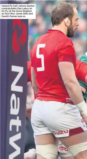  ??  ?? Ireland fly-half Johnny Sexton congratula­tes Dan Leavy on his try at the Aviva Stadium as Alun Wyn Jones (left) and Gareth Davies look on