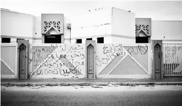  ??  ?? Writings on the wall of the former headquarte­r of ISIS religious police or Nisbah. On the right wall is written ‘Fury,’ the name of the militia that is now in control of the building and then ‘history is made by strong men.’ On the left the writing...