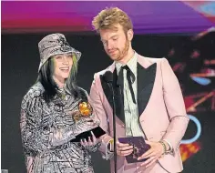  ??  ?? Billie Eilish and Finneas with the record of the year award.