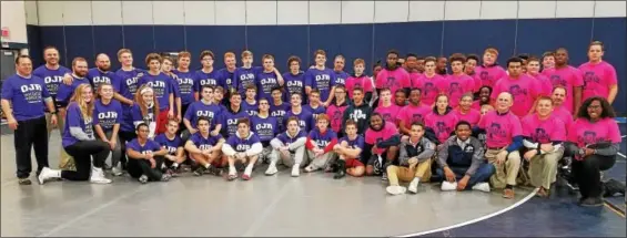  ?? AUSTIN HERTZOG - DIGITAL FIRST MEDIA ?? The Owen J. Roberts and Pottstown wrestling teams come together for a post-match photo Wednesday at Pottstown.