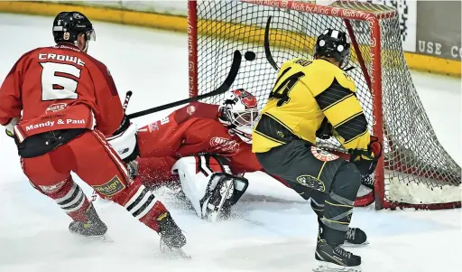  ?? Geoff White ?? ● The Solihull keeper pulls off an acrobatic save to flick the puck over the bar from a Danny Haid shot