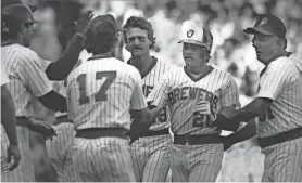  ?? JOURNAL SENTINEL FILES ?? Charlie Moore (second from right, shown here in 1985) hit for the cycle in 1980, the first of three Brewers catchers to accomplish the feat.