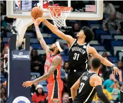  ?? (Reuters) ?? NEW ORLEANS PELICANS forward Brandon Ingram (left) has his shot blocked by Brooklyn Nets center Jarrett Allen during the second half of the Nets’ 108-101 overtime victory over the host Pelicans on Tuesday night.