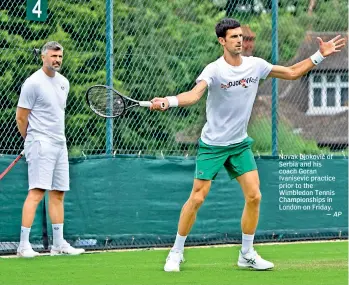  ?? — AP ?? Novak Djokovic of Serbia and his coach Goran Ivanisevic practice prior to the Wimbledon Tennis Championsh­ips in London on Friday.