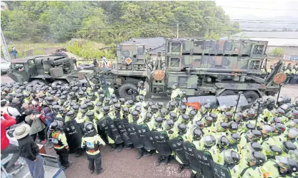  ?? YONHAP VIA AP ?? A US military vehicle moves as South Korean police officers try to block residents and protesters who oppose a plan to deploy an advanced missile defence system called Terminal High Altitude Area Defence in Seongju yesterday.