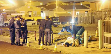  ?? Picture Leon Knipe ?? CAPE TOWN: The body of a man, believed to be a member of the Americans gang, lies in Hangberg Road in Tafelsig.