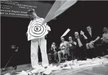  ?? Michael Dwyer / Associated Press ?? Eric Workman, known as the Human Aerodrome, becomes a target for paper planes during the Ig Nobel award ceremonies.