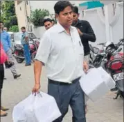  ?? HT PHOTO ?? An official with documents seized during the raids.