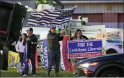  ?? ASSOCIATED PRESS FILE PHOTO ?? Supporters of President Donald Trump campaign at a busy intersecti­on in Cranberry Township, Pa., during rush hour.
