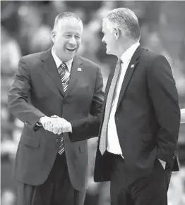  ?? DAVID ZALUBOWSKI AP ?? Air Force coach Dave Pilipovich (left) and Aztecs coach Brian Dutcher shake hands during SDSU’S 89-74 victory in the teams’ only meeting this season.