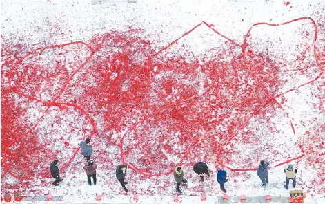  ??  ?? Shop owners set off firecracke­rs on the first national working day after the Chinese Lunar New Year holiday to pray for their good fortune in business, in Shenyang, Liaoning province. — Reuters photo