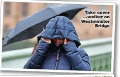  ?? ?? Take cover ...walker on Westminste­r Bridge