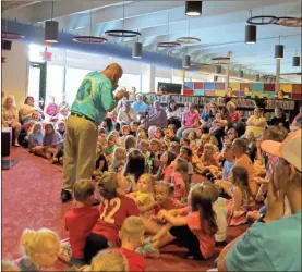  ?? / Contribute­d ?? Above:
Ron Anglin brought laughter and joy to local youth at the Rockmart Library, the first in many shows this summer. Carson Waller took part in a trick performed by Ron Anglin at Rockmart Library.
Left: