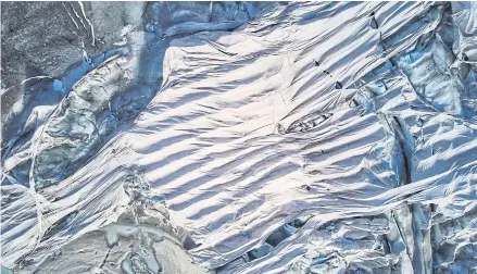  ?? REUTERS ?? Protection material preventing the ice from melting is pictured with a drone on the Rhone glacier in Obergoms, Switzerlan­d in October last year.