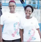  ?? ?? These two ladies wore breast cancer T-shirts while watching the game at Mhlume Stadium.