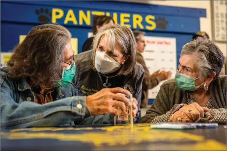  ?? NATHAN BURTON/Taos News ?? Gov. Michelle Lujan Grisham talks with wildfire evacuees Barney and Jenny Torres of Cleveland on Wednesday (May 4) at the Peñasco evacuation center.