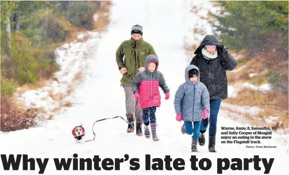  ?? Photo / Peter McIntosh ?? Wayne, Amie, 8, Samantha, 10, and Sally Cooper of Mosgiel enjoy an outing in the snow on the Flagstaff track.