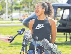  ?? — AFP photo ?? Naomi Osaka of Japan speaks to the media after a sightseein­g ride in a helicopter at the Queensland Tennis Centre in Brisbane.