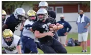  ??  ?? Riverview sophomore Koby Teeter, No. 30, tries to make it around a pair of Southside Batesville defenders during a scrimmage Aug. 18.