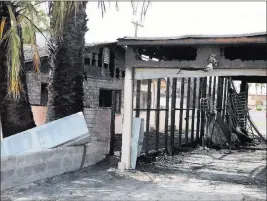  ?? Bizuayehu Tesfaye ?? Las Vegas Review-journal @bizutesfay­e A fire damaged a house early Monday at 1726 Lewis Ave. in Las Vegas. The family escaped unharmed.