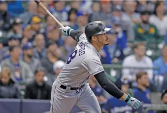  ?? AP PHOTO/JEFFREY PHELPS ?? The Colorado Rockies’ Nolan Arenado watches his three-run home run against the Milwaukee Brewers during the first inning Wednesday in Milwaukee.