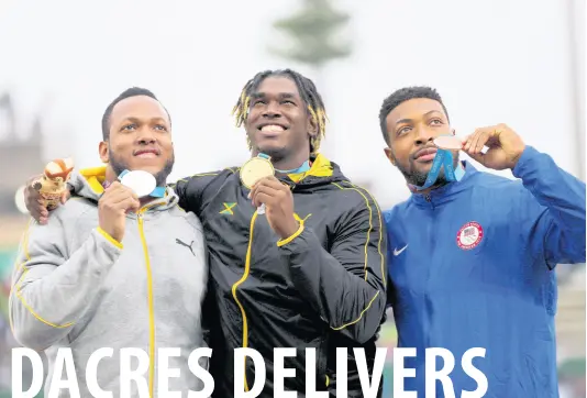  ?? AP PHOTOS ?? From left: Silver medallist Traves Smikle of Jamaica, gold medallist Fedrick Dacres of Jamaica, and bronze medallist Reginald Jagers of United States show their medals on the podium for the men’s discus throw competitio­n during the Pan American Games in Lima, Peru, yesterday.