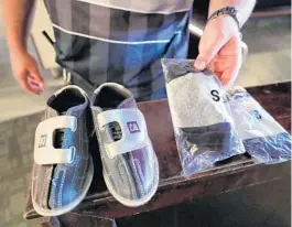  ??  ?? Personal shoe covers called ‘bowling buddies’ at now sold at Splitsvill­e. They allow customers to wear their own shoes.