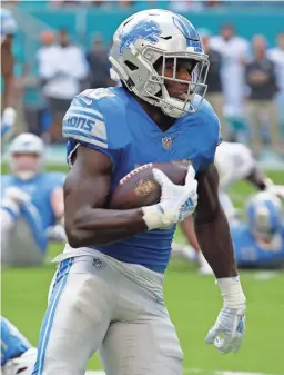  ?? LYNNE SLADKY/AP ?? Lions running back Kerryon Johnson carries against the Dolphins on Sunday in Miami Gardens, Fla.