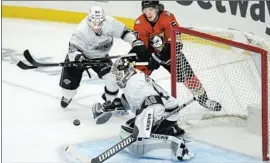  ?? Ashley Landis Associated Press ?? KINGS goaltender Cal Petersen blocks a shot during the first period against the Ducks at Staples Center. It was the second of a four-game series between the two.