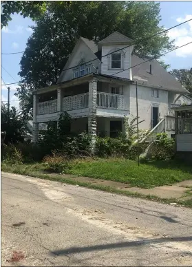  ??  ?? The house at 907 Seventh Court in Lorain, shown at right, before demolition began Sept. 1. Crews from ProSupply Inc. in Cleveland demoloshed the structure, and a second one on the site.