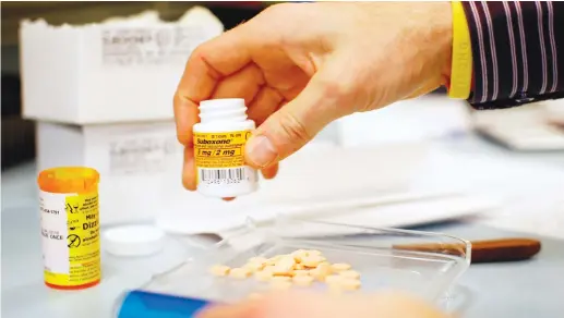  ?? (Brian Snyder/Reuters) ?? A PHARMACIST fills out a prescripti­on for opioid replacemen­t therapy drug Suboxone in Boston. Pharmaceut­ical companies such as Teva have faced widespread condemnati­on over their alleged role in the opioid epidemic.